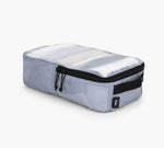 Silver rectangular packing cube with black zippered top and dual zipper pulls