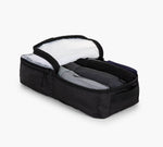Black rectangular packing cube with open zippered lid and three rolled shirts inside