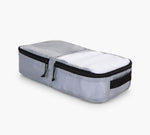 Light gray rectangular packing cube with dual black zippers and side handle