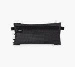 Flat clip-in pouch in black grid fabric with zipper and visible label reading 'Pakt.'