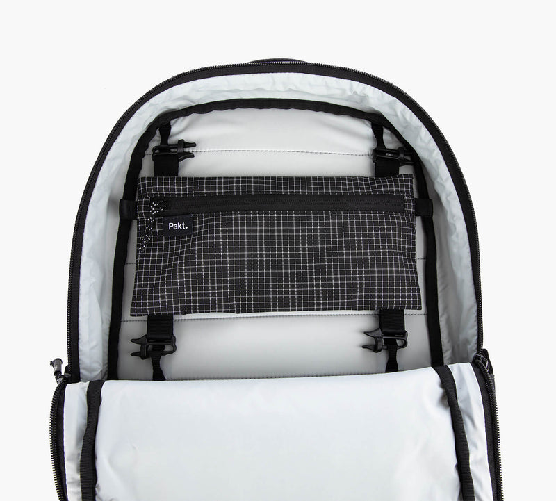 Black and white checkered Clip-In Pouch with clips inside a white sling bag