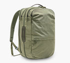 Three-quarter view of Pakt One Travel Backpack in cypress showing three zip compartments, side carry handle, and padded shoulder straps on white background
