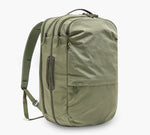 Olive-green backpack with two front zip compartments, side carry handle and padded shoulder straps.