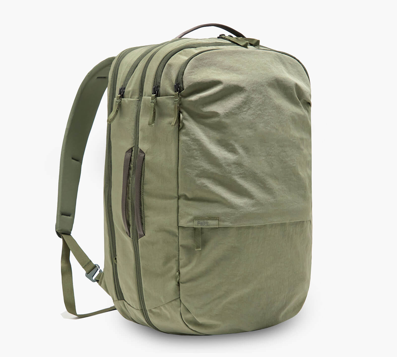 Three-quarter view of Pakt One Travel Backpack in cypress showing three zip compartments, side carry handle, and padded shoulder straps on white background
