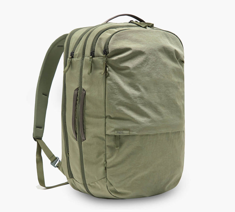 Olive-green backpack with two front zip compartments, side carry handle and padded shoulder straps.