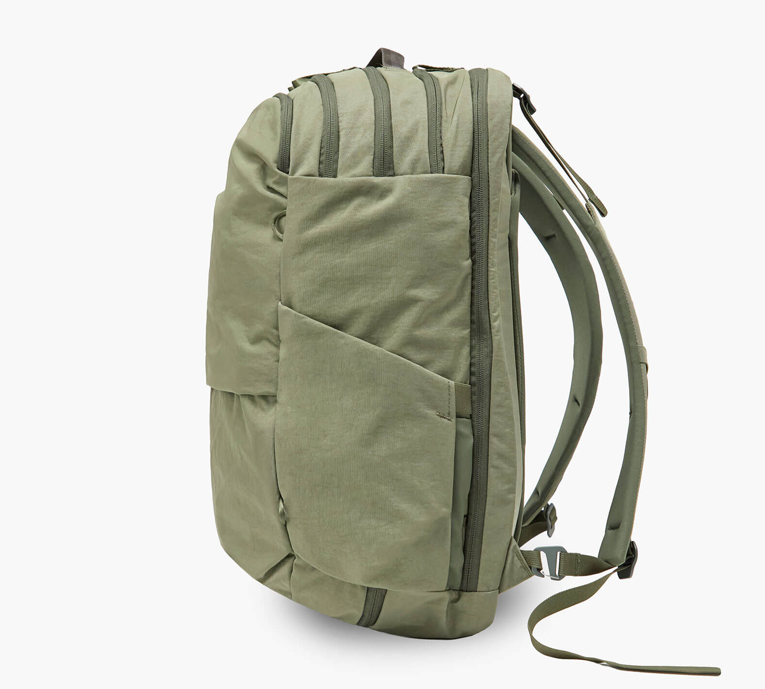 Olive green backpack, side profile showing padded shoulder straps, exterior zip pocket, and top carry handle