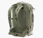Olive-green tactical backpack viewed from rear showing padded back panel, harness straps, sternum strap and hip belt