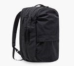 Black travel backpack with padded shoulder straps, multiple zippered compartments and a front pocket.
