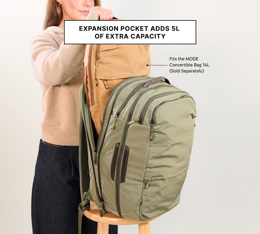 Three-quarter view of Pakt One Travel Backpack in cypress showing expansion pocket adds 5L on neutral background