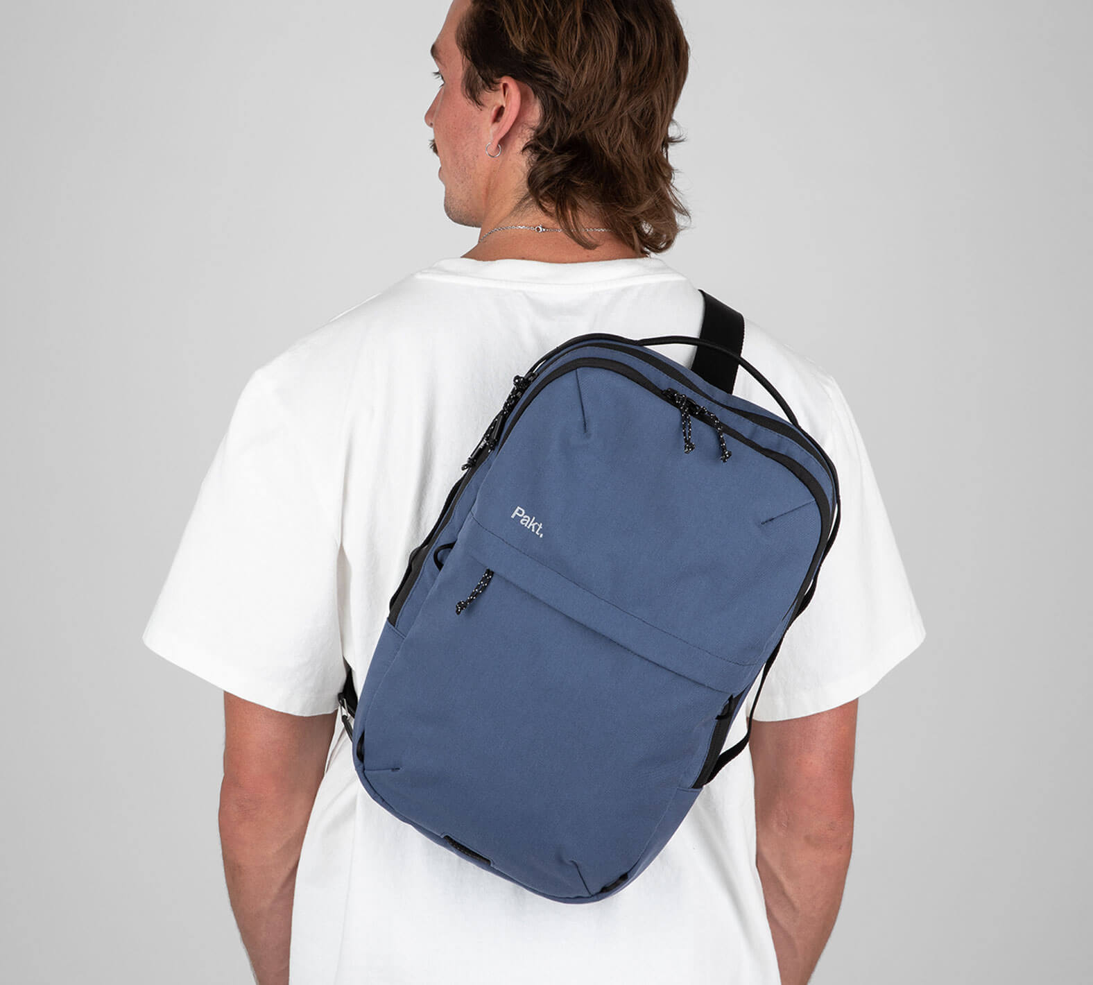 Man with blue sling backpack