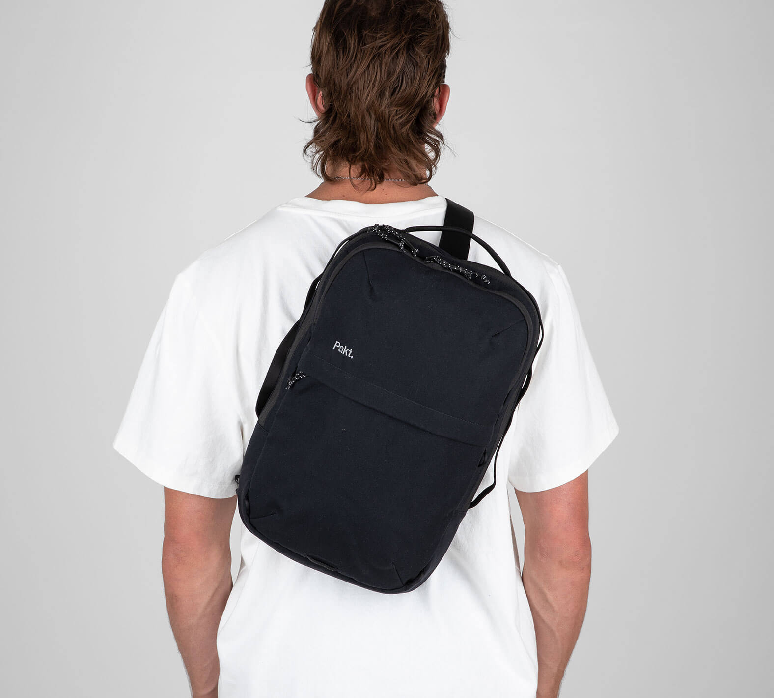 Man with black sling backpack
