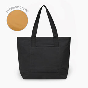 The Stash Tote in Black with black handles on a white background. To the left there is a circular swatch showing the interior color, which is Mojave.