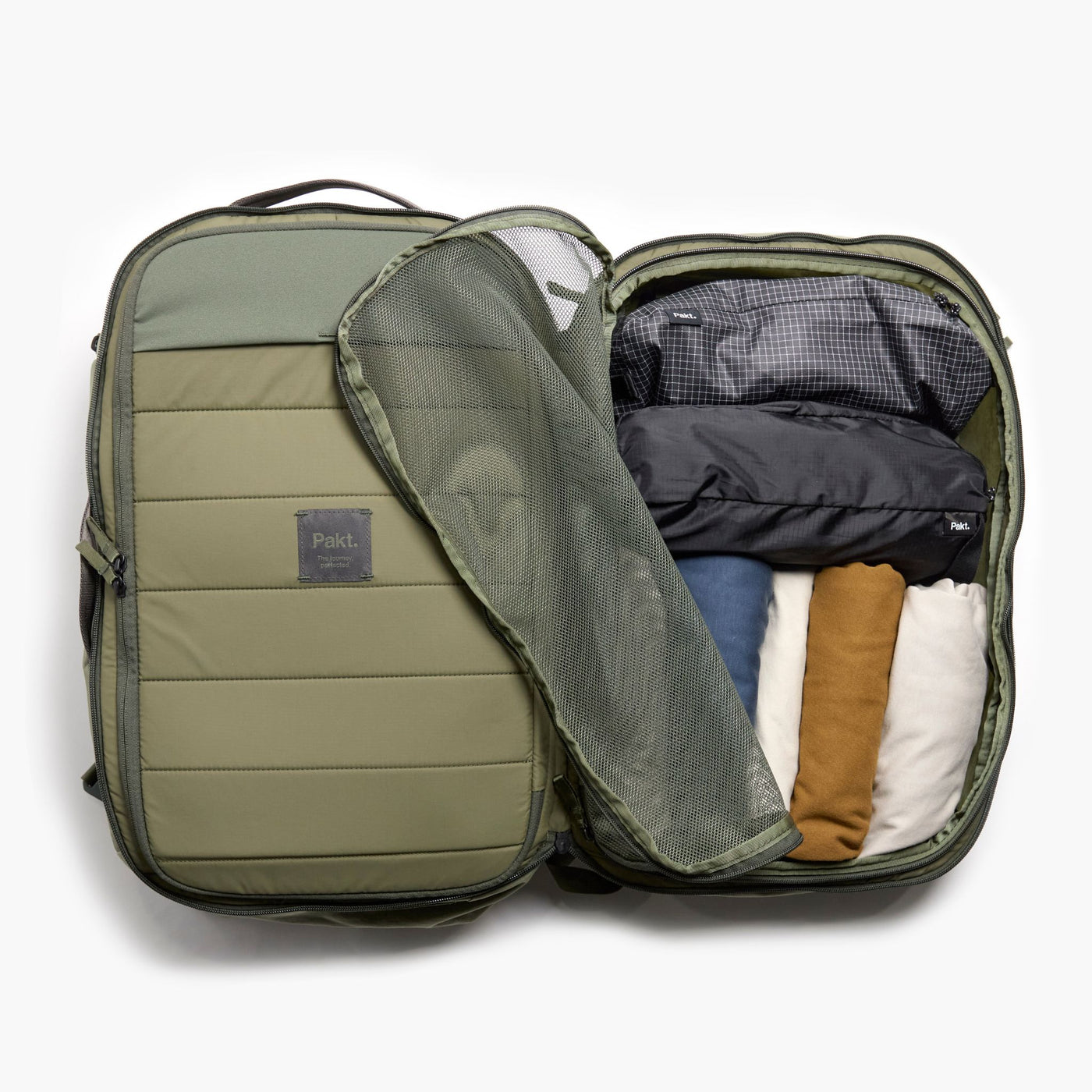Overhead view of Pakt One Travel Backpack interior showing mesh divider and packing cubes in cypress on white background