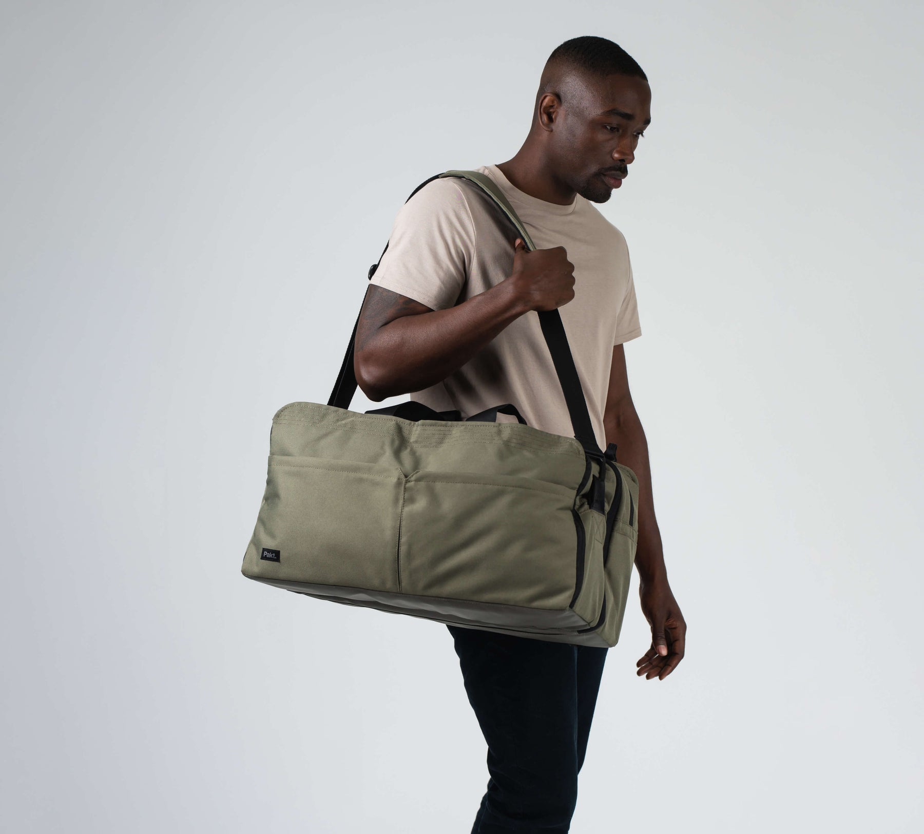 the 50L anywhere duffel with shoulder strap on a male model