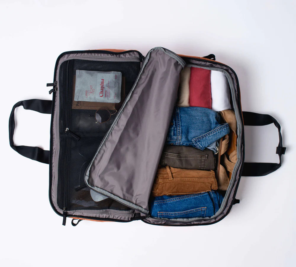 Pack each side of the 50L bag with clothing and other travel essentials