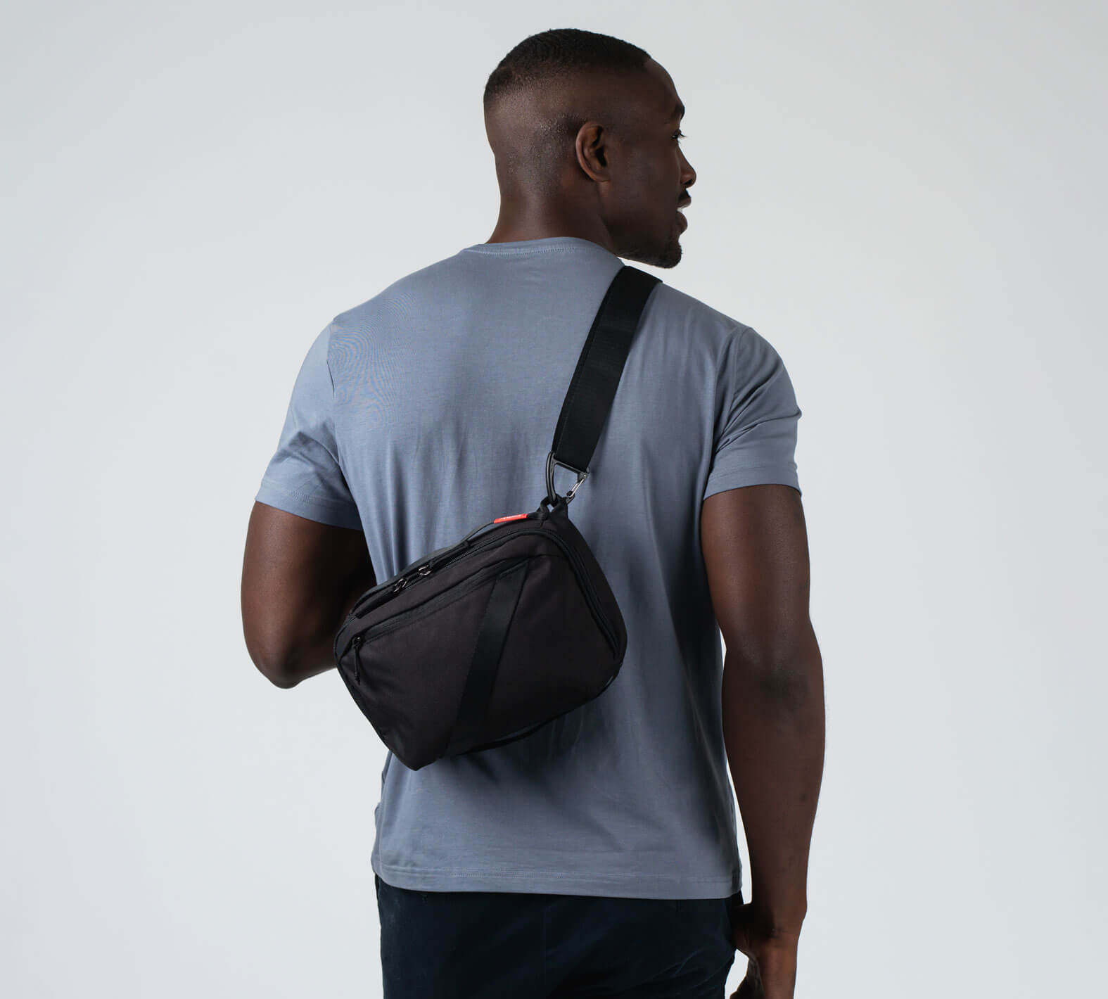 The 5L Anywhere Sling in Black on a male model