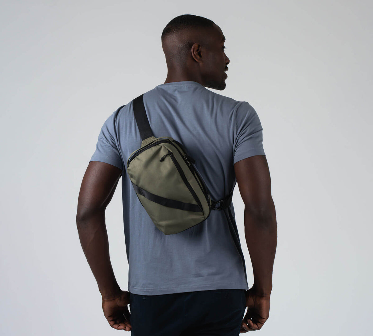 The 5L Anywhere Sling in Green on a male model