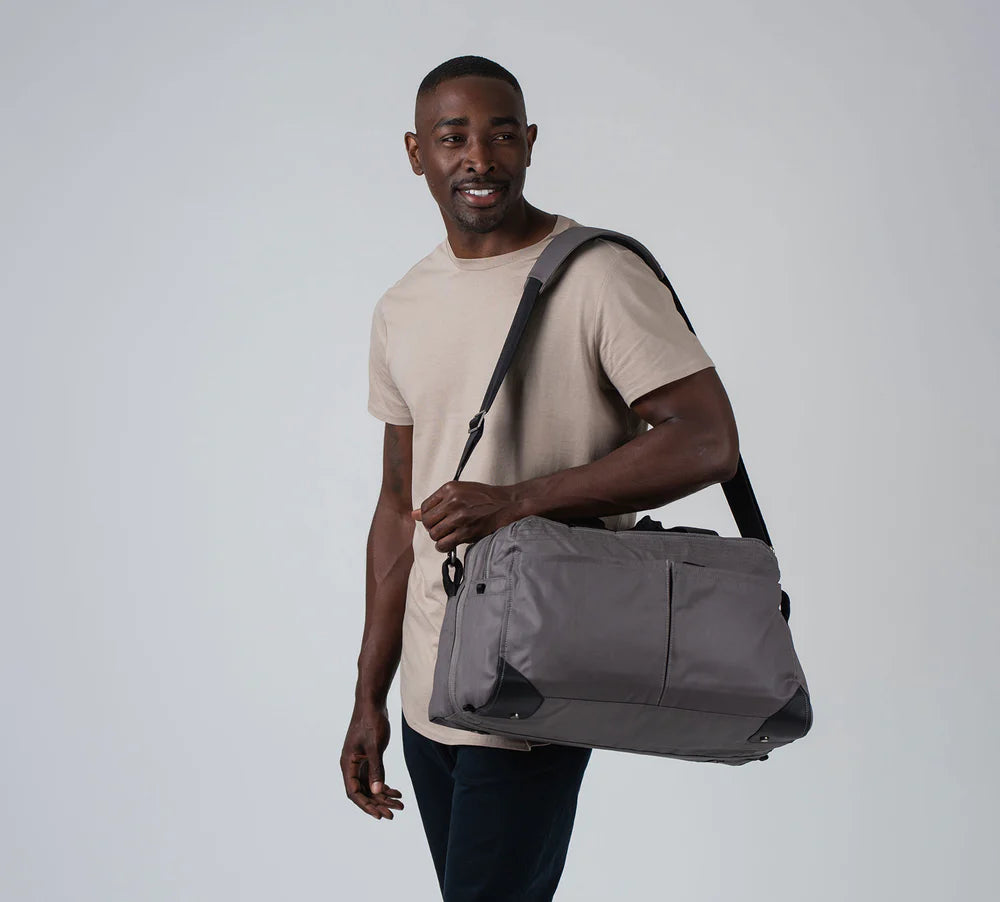 male model with the pakt one duffel
